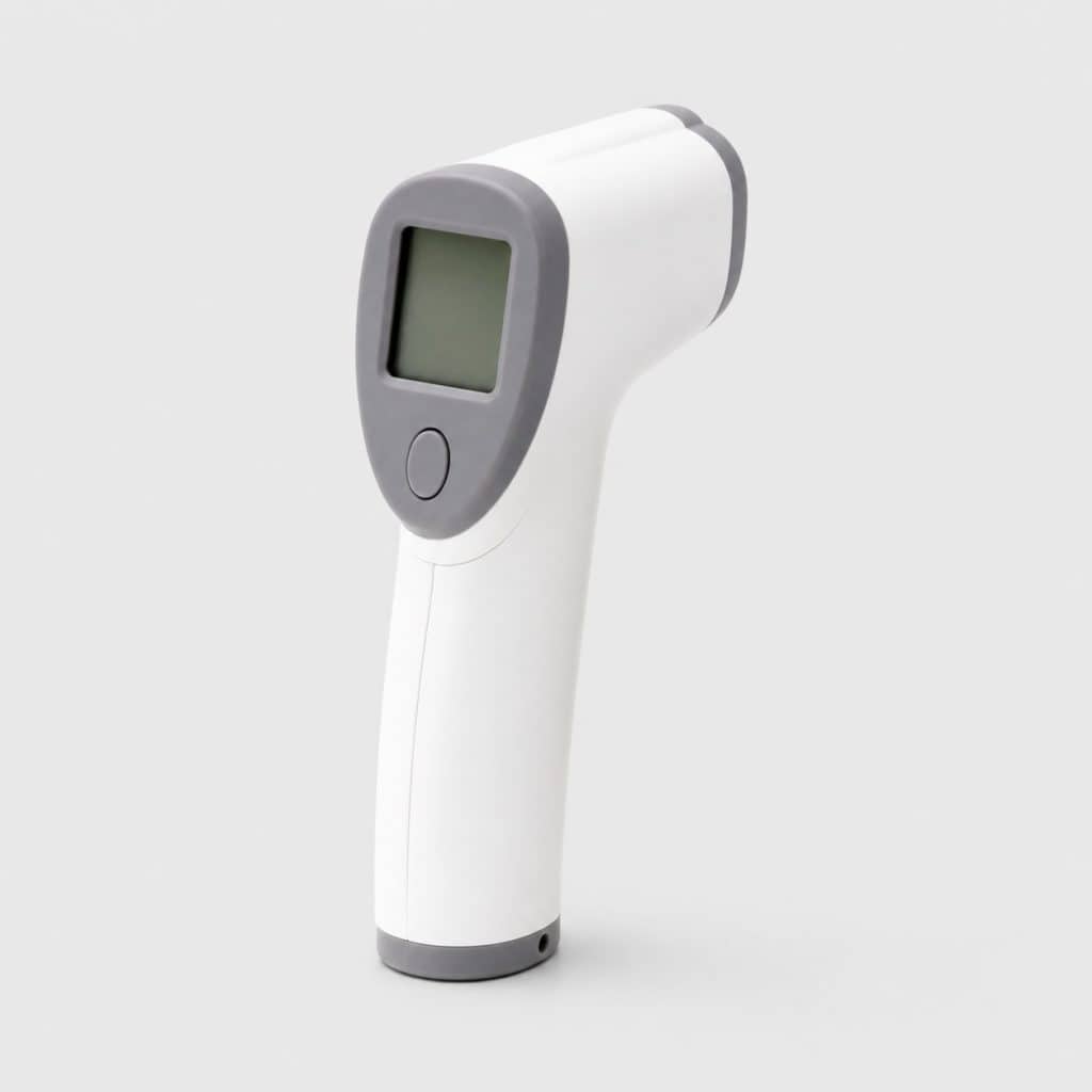 Thermomètre frontal connecté posé sur fond neutre