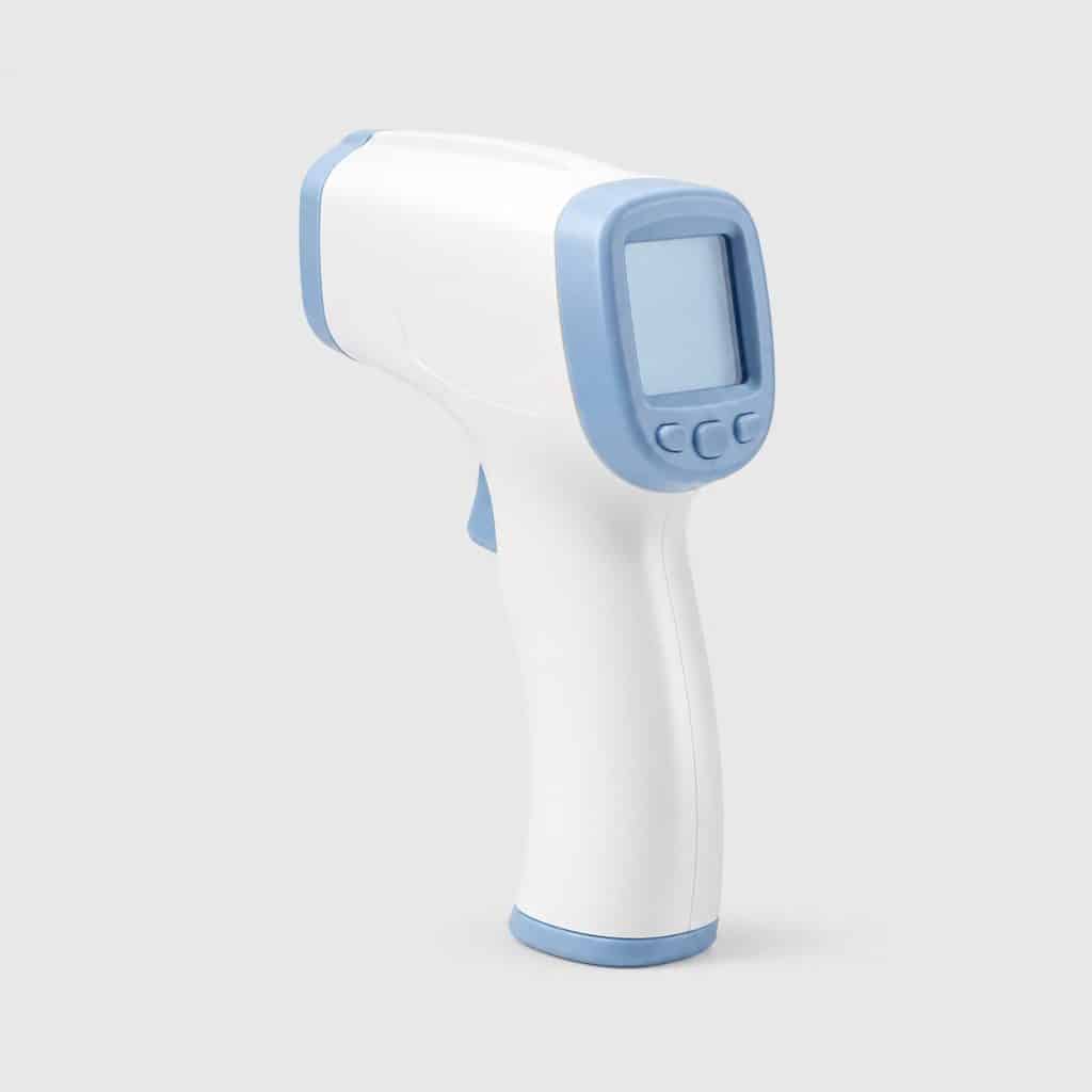 Thermomètre frontal sans contact à infrarouge sur fond neutre